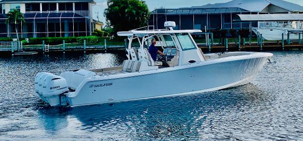 Sailfish 360 CC ELITE - CLEAN CLEAN CLEAN w ONLY 216 HOURS 2020 Sailfish 360 CC Elite boat on water, side view, with dual engines.