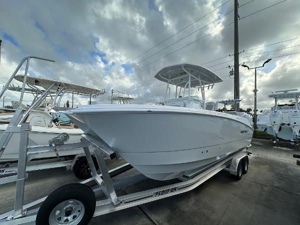 Twin Vee 240 GFX CC 2025 Twin Vee 240 GFX CC boat on trailer under cloudy sky.
