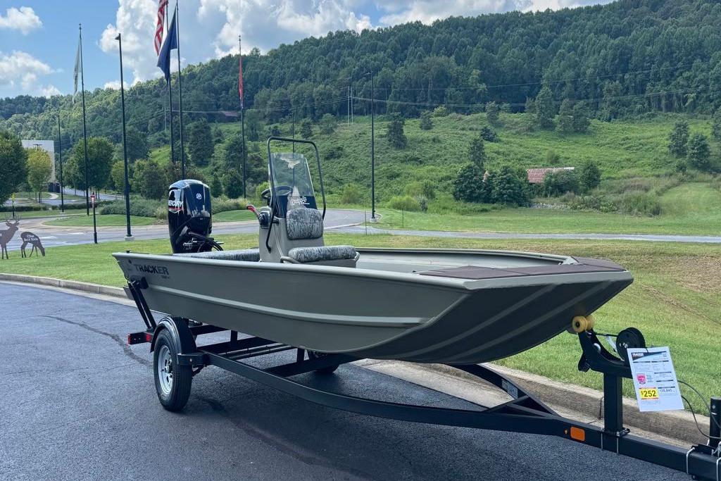 Tracker Grizzly 1860 CC 2026 Tracker Grizzly 1860 CC boat on trailer, scenic outdoor setting.