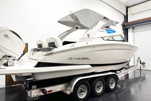 Regal LX9 2026 Regal LX9 boat on trailer in indoor showroom.