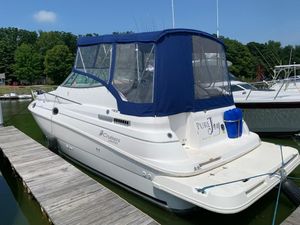 Cruisers Rogue 2870 1998 Cruisers 2870 Rogue yacht docked with blue canopy and "Pure Joy" name.
