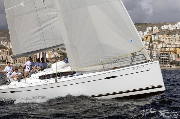 Dehler 41 Sailing yacht Dehler 41, 2012 model, navigating coastal waters with cityscape background.