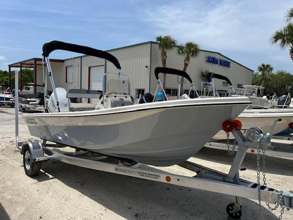Carolina Skiff 178 JLS 2025 Carolina Skiff 178 JLS boat on trailer, parked outside a marine dealership.