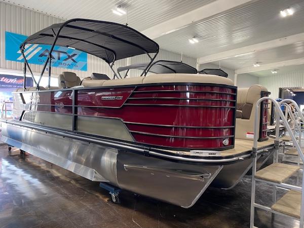 SunCatcher Elite 324 RC 2025 SunCatcher Elite 324 RC pontoon boat with sleek design in showroom.
