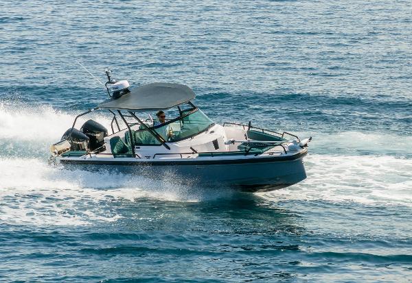 Axopar 28 T-Top 2022 Axopar 28 T-Top boat cruising on open water.