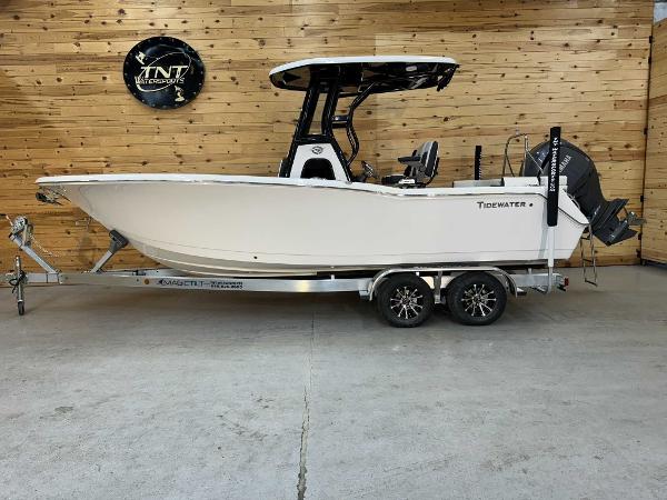 Tidewater 232SS 2024 Tidewater 232SS boat on trailer in showroom with wooden wall background.