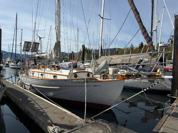 Tayana 37 1985 Tayana 37 sailboat docked in a marina, surrounded by other boats.