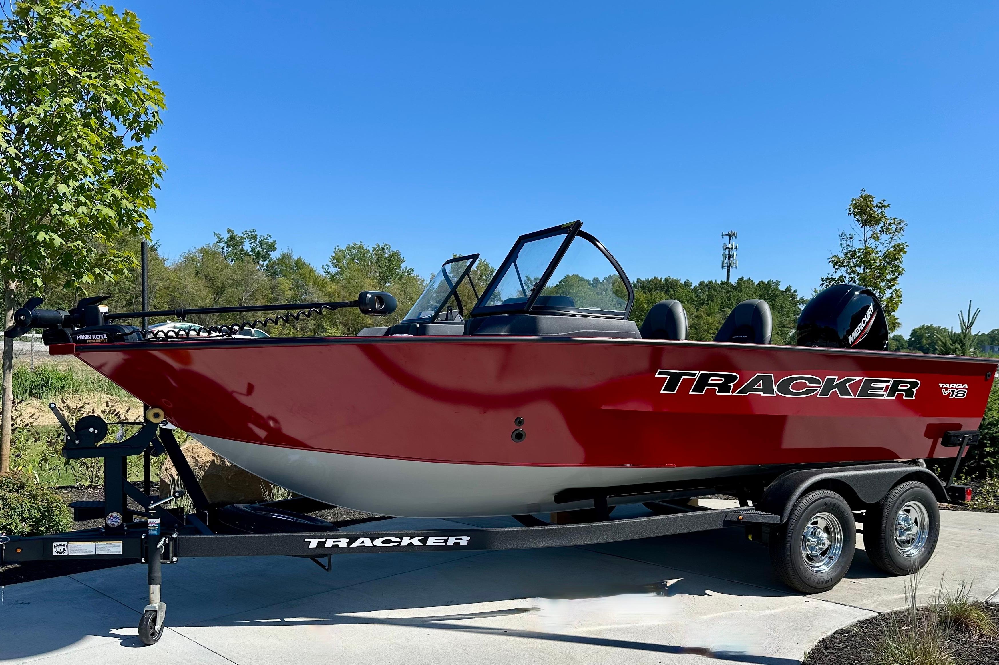 Tracker Targa V-18 WT 2026 Tracker Targa V-18 WT boat on trailer, red exterior, parked outdoors.