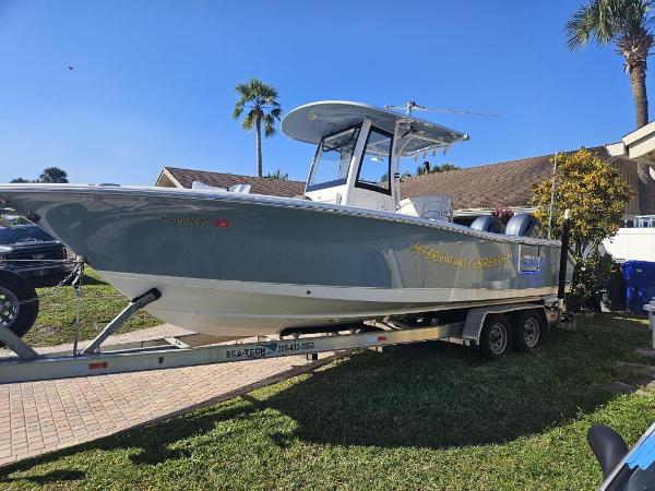 Sea Hunt Gamefish 25 2021 Sea Hunt Gamefish 25 boat on a trailer in a residential area.