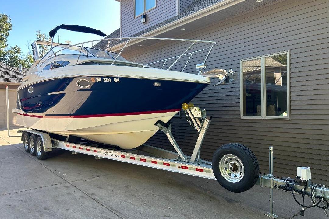 Regal 30 Express 2017 Regal 30 Express boat on trailer beside house.