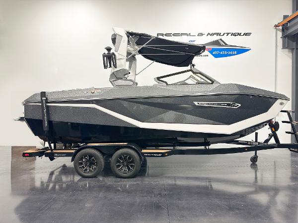 Nautique Super Air Nautique G21 2025 Nautique Super Air Nautique G21 boat on trailer in showroom.