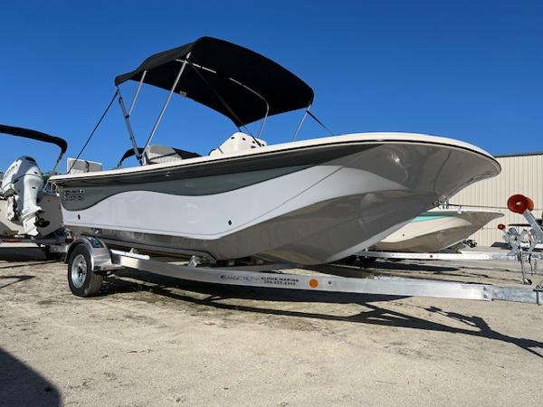 Carolina Skiff 19 LS 2025 Carolina Skiff 19 LS boat on trailer, featuring sleek design and bimini top.