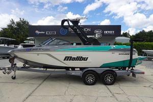 Malibu Wakesetter 22 LSV 2021 Malibu Wakesetter 22 LSV boat on trailer, parked outdoors under a cloudy sky.