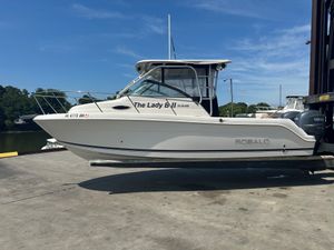 Robalo R245 Walkaround 2008 Robalo R245 Walkaround boat on a dock with clear blue sky.