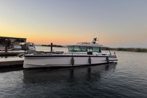 Axopar 37 XC Brabus 2022 Axopar 37 XC Brabus boat docked at sunset, calm waters, serene atmosphere.