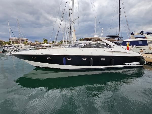 Sunseeker Camargue 50 2003 Sunseeker Camargue 50 yacht docked in a marina under cloudy skies.