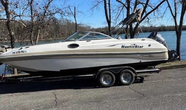 NauticStar 230DC Sport Deck 2010 NauticStar 230DC Sport Deck boat on trailer by a lake.