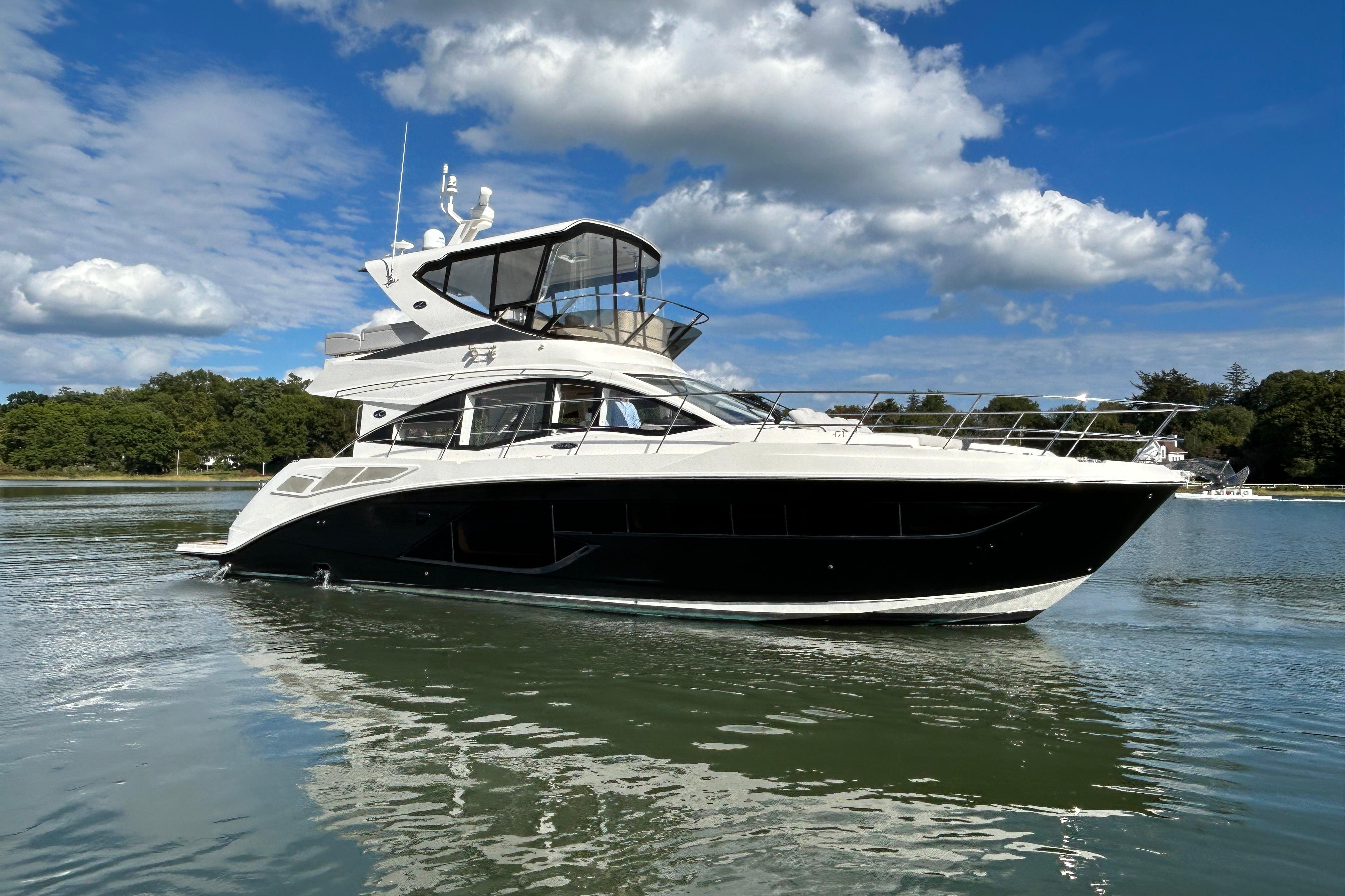 Sea Ray Fly 520 2018 Sea Ray Fly 520 yacht on calm water under a blue sky.