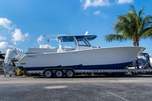 Front Runner 39 Center Console 2026 Front Runner 39 Center Console boat on trailer, under clear blue sky with palm tree.