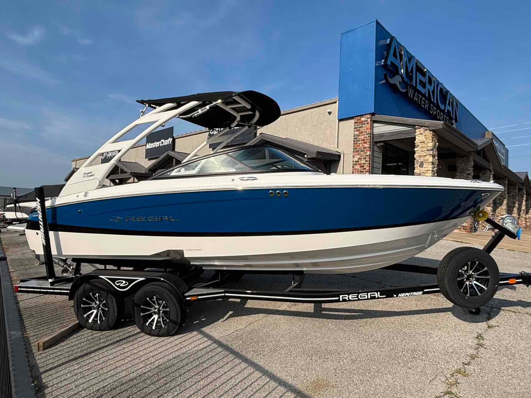Regal LS2 SURF 2024 Regal LS2 SURF boat on trailer at American Water Sports dealership.