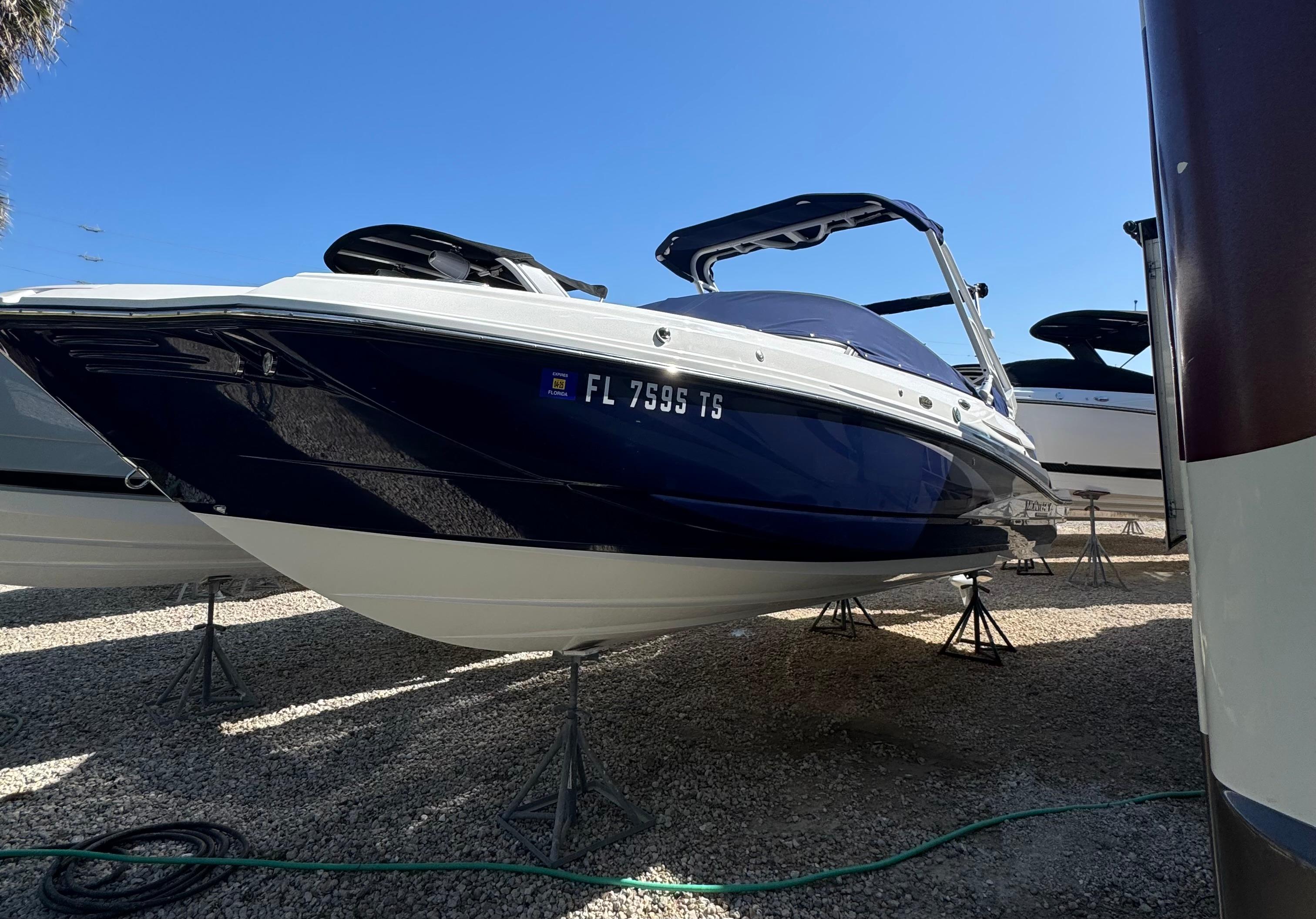 Monterey M-45 2023 Monterey M-45 boat on stands, blue and white hull, clear sky background.
