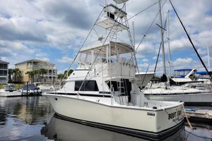 Bertram 38 Convertible 1979 Bertram 38 Convertible yacht docked at marina under cloudy sky.