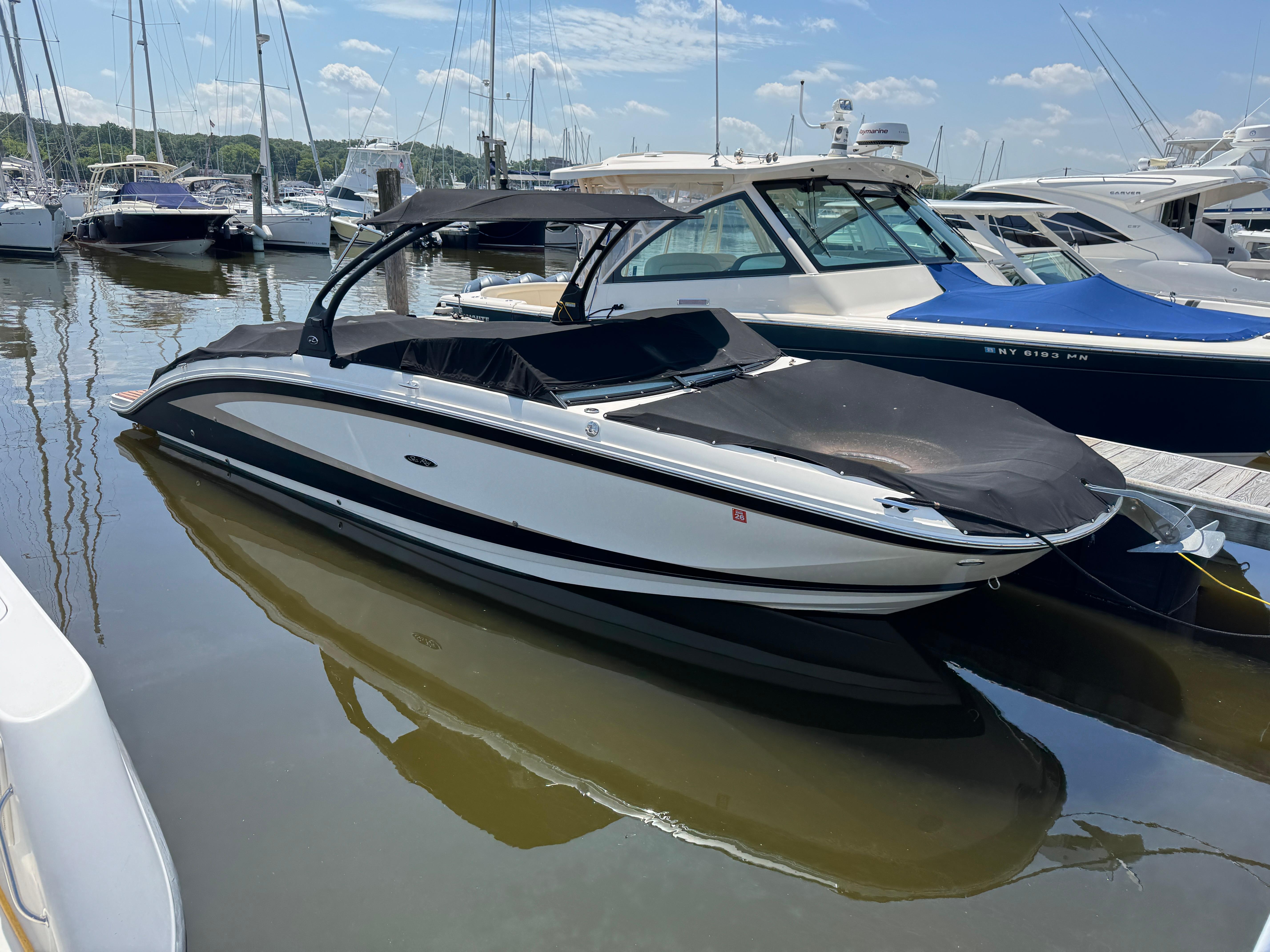 Sea Ray 290 Sundeck 2015 Sea Ray 290 Sundeck boat docked in a marina, covered and ready for use.