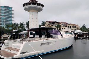 Fjord 40 Open 2015 Fjord 40 Open yacht docked near a lighthouse and waterfront buildings.