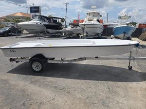 Custom XPC 16 Custom XPC 16 boat on trailer, 2025 model, displayed outdoors with other boats.