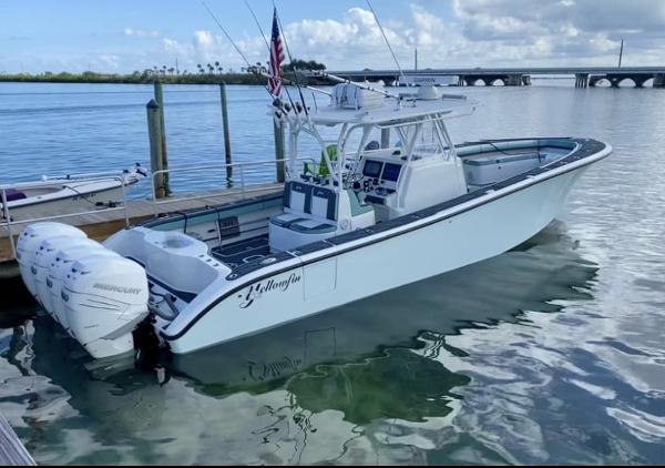 Yellowfin 39 2016 Yellowfin 39 boat docked, featuring triple Mercury outboard engines.