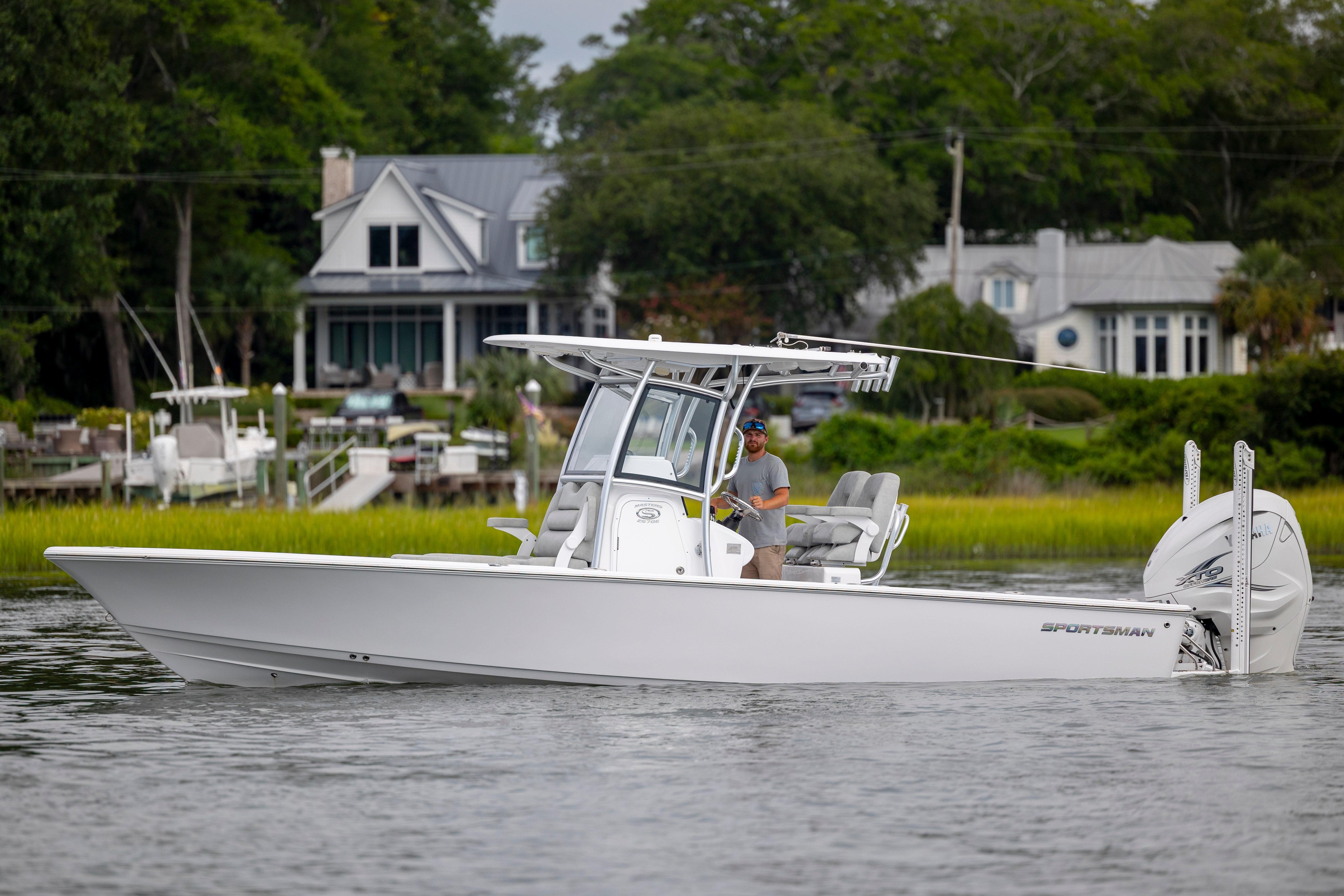 Sportsman Masters 267OE Bay Boat 2020 Sportsman Masters 267OE Bay Boat cruising on a scenic waterway.
