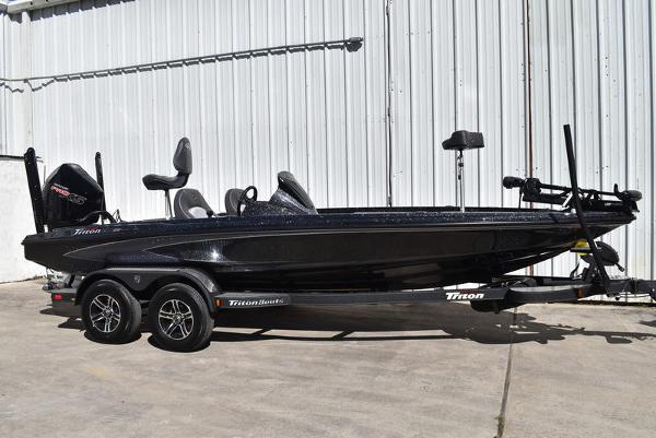 Triton 20XP Patriot 2025 Triton 20XP Patriot boat on trailer, sleek black design, parked outdoors.