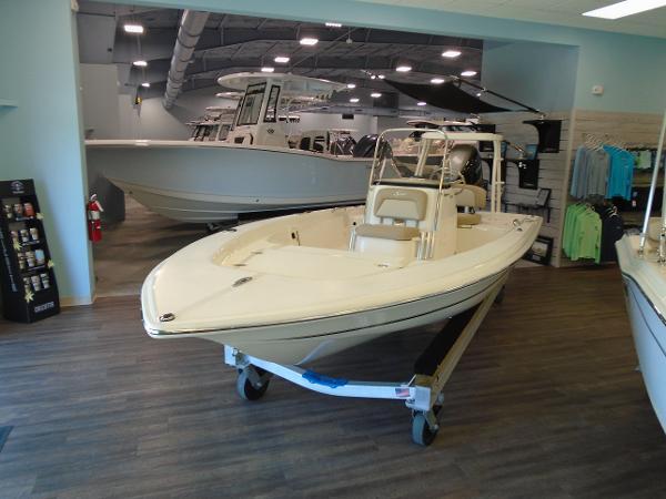 Scout 177 Sport 2025 Scout 177 Sport boat displayed in a showroom with wooden flooring.