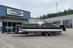 Barletta Aria 24UC 2025 Barletta Aria 24UC pontoon boat on trailer outside Marine Sales building.
