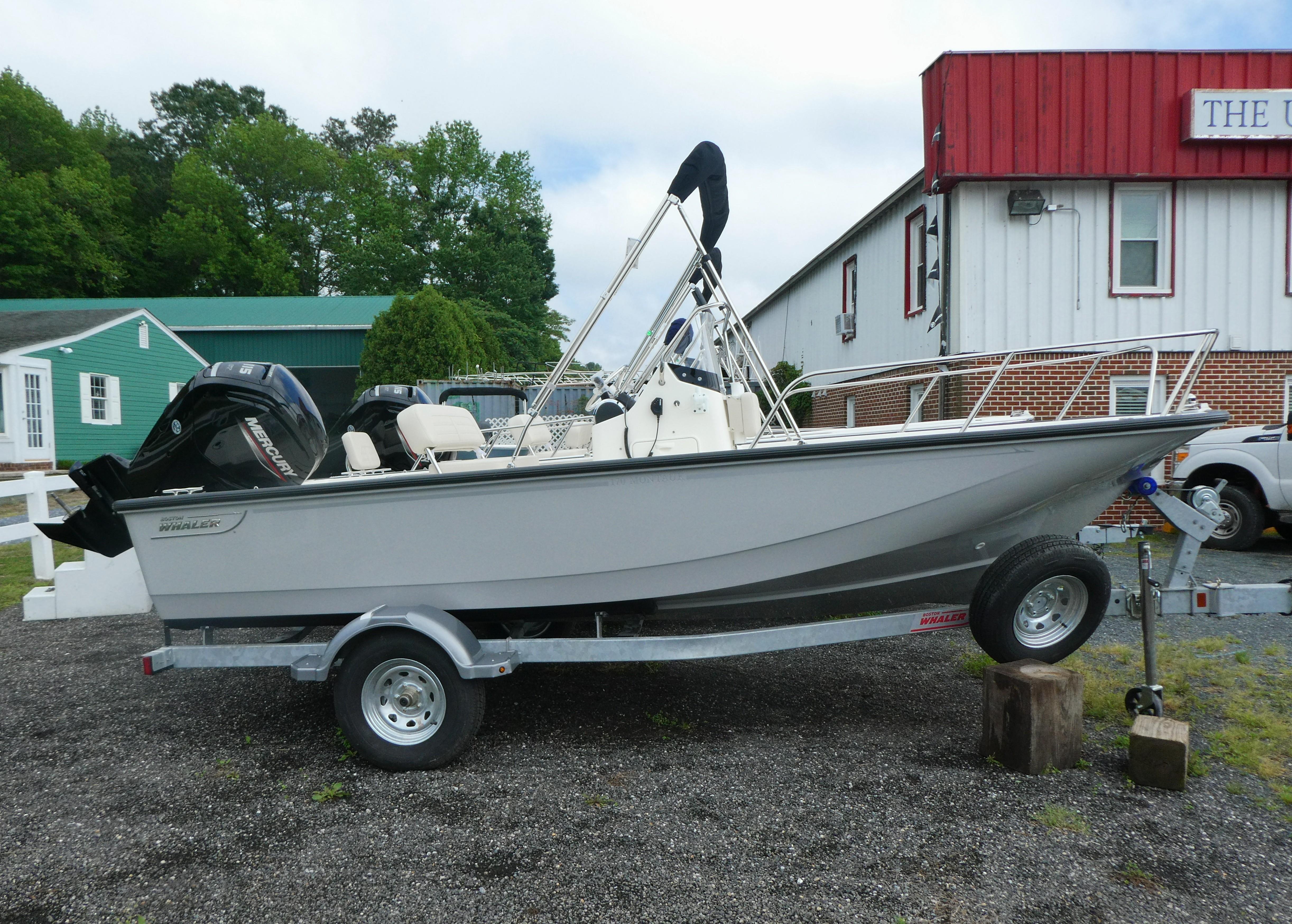 Boston Whaler 170 Montauk 2025 Boston Whaler 170 Montauk boat on trailer, parked outdoors near buildings.