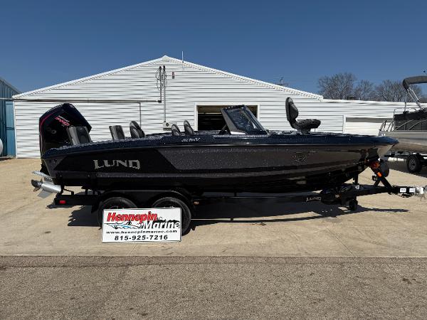 Lund 202 Pro-V GL 2025 Lund 202 Pro-V GL boat on trailer outside Hennepin Marine dealership.