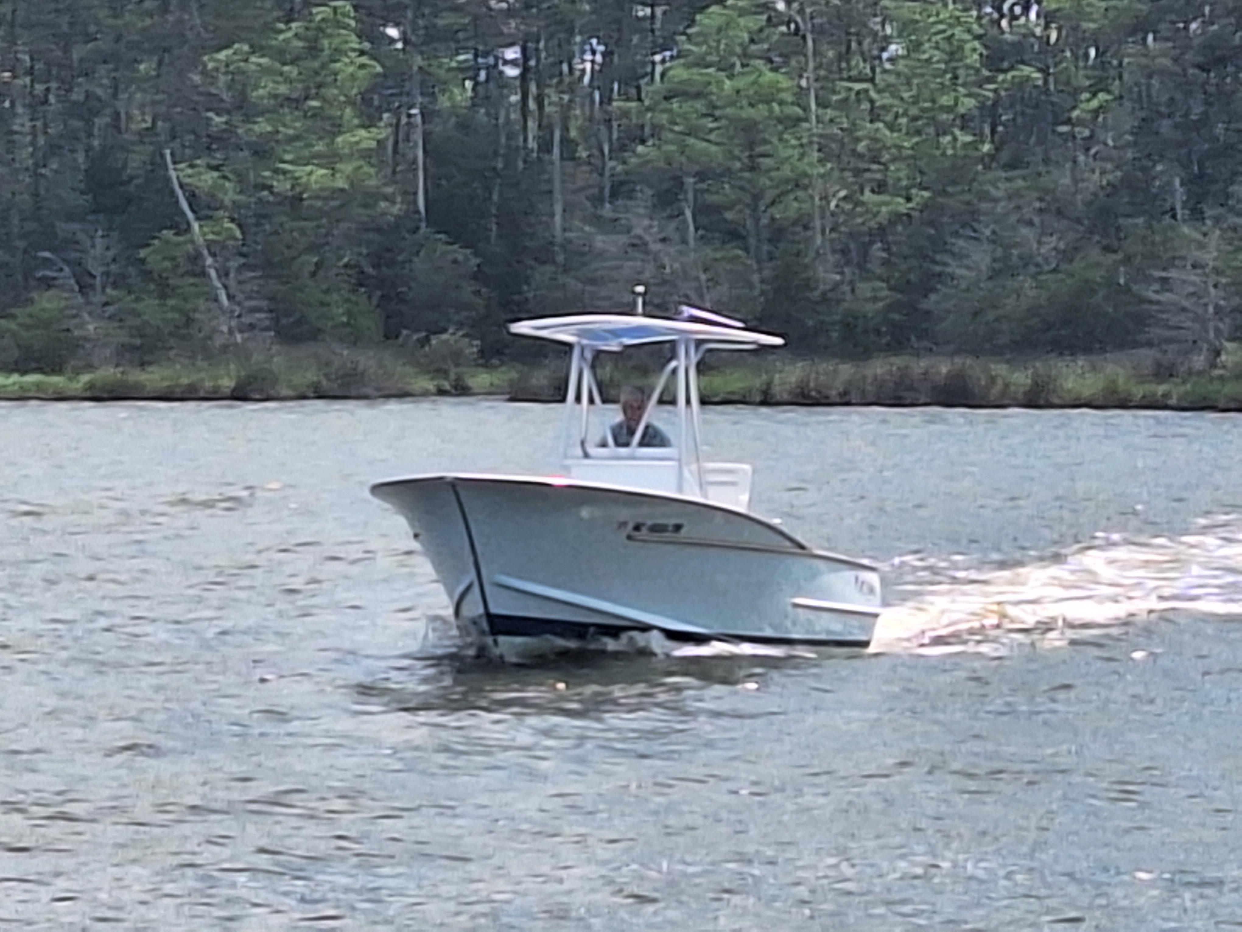Custom Carolina CUSTOM CAROLINA 2008 Custom Carolina boat cruising on a river with forested background.