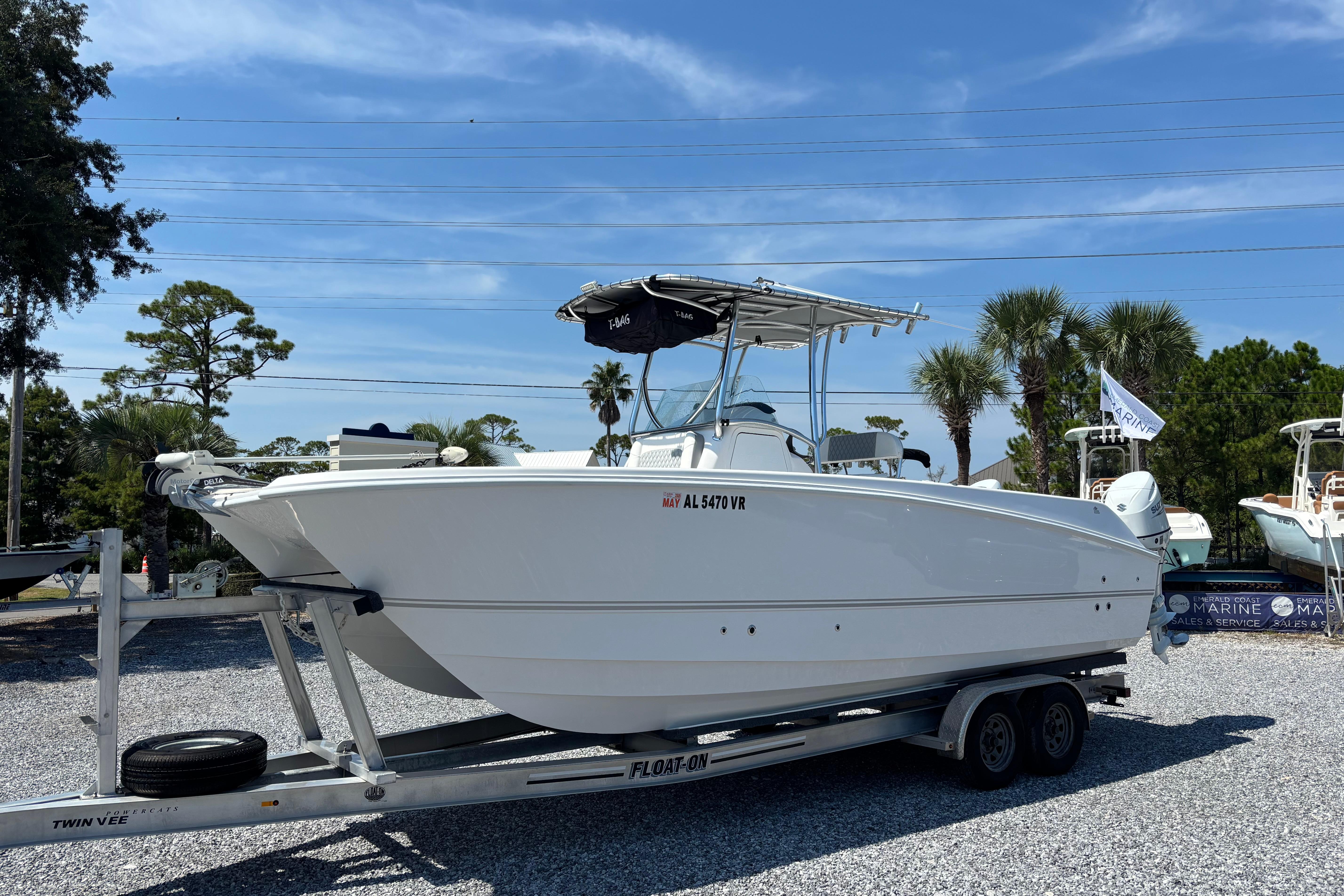 Twin Vee 240 GFX CC 2022 Twin Vee 240 GFX CC boat on trailer, displayed outdoors under clear sky.