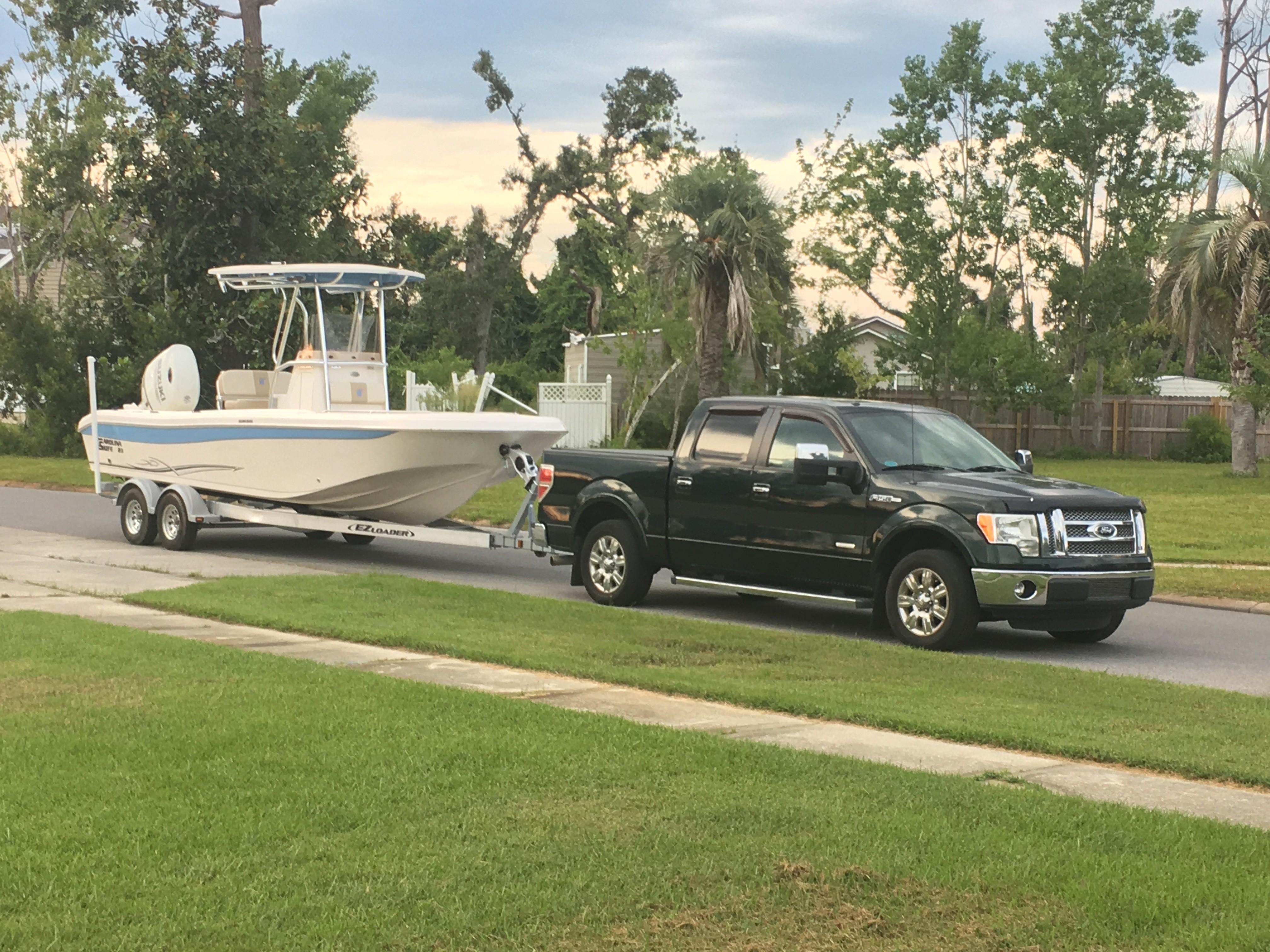 Carolina Skiff 23 Ultra Elite 2019 Carolina Skiff 23 Ultra Elite boat on trailer, towed by a black pickup truck.