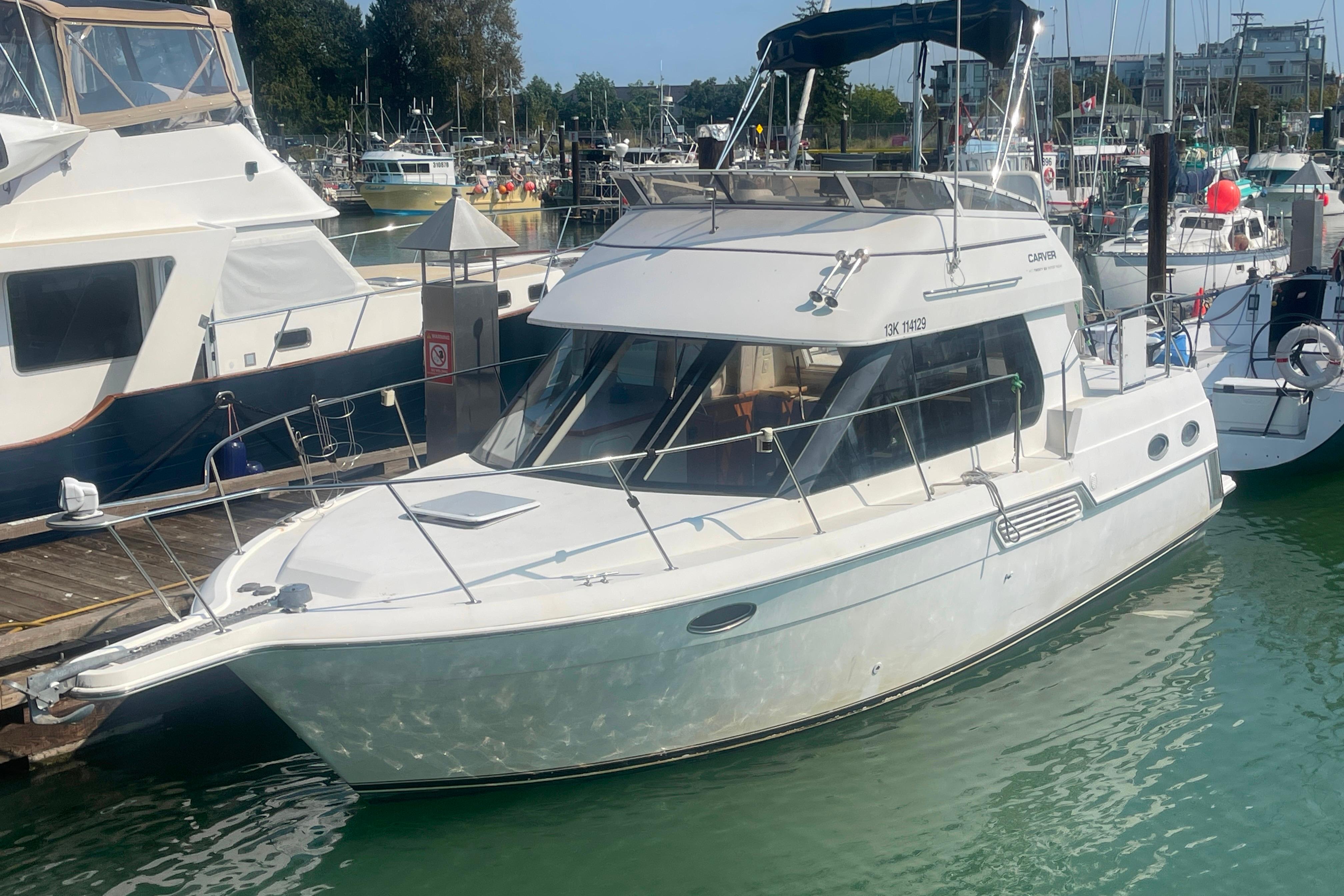 Carver 326 Aft Cabin Motor Yacht Carver 326 Aft Cabin Motor Yacht 2000 docked in a marina, surrounded by other boats.