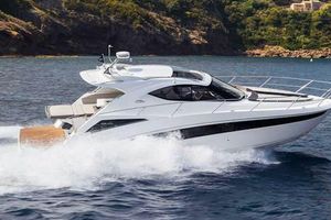 Galeon 405 HTL 2017 Galeon 405 HTL yacht cruising on open water, scenic coastal backdrop.