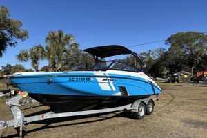 Yamaha Boats 212XE 2021 Yamaha Boats 212XE on trailer, blue and white, parked outdoors with trees in background.
