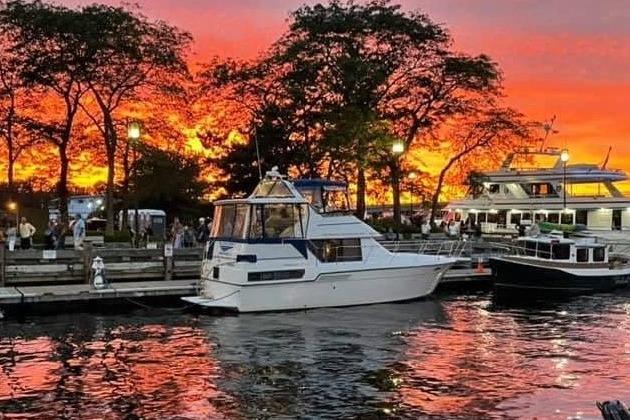 Carver 350 1994 Carver 350 yacht docked at sunset, vibrant sky reflecting on water.