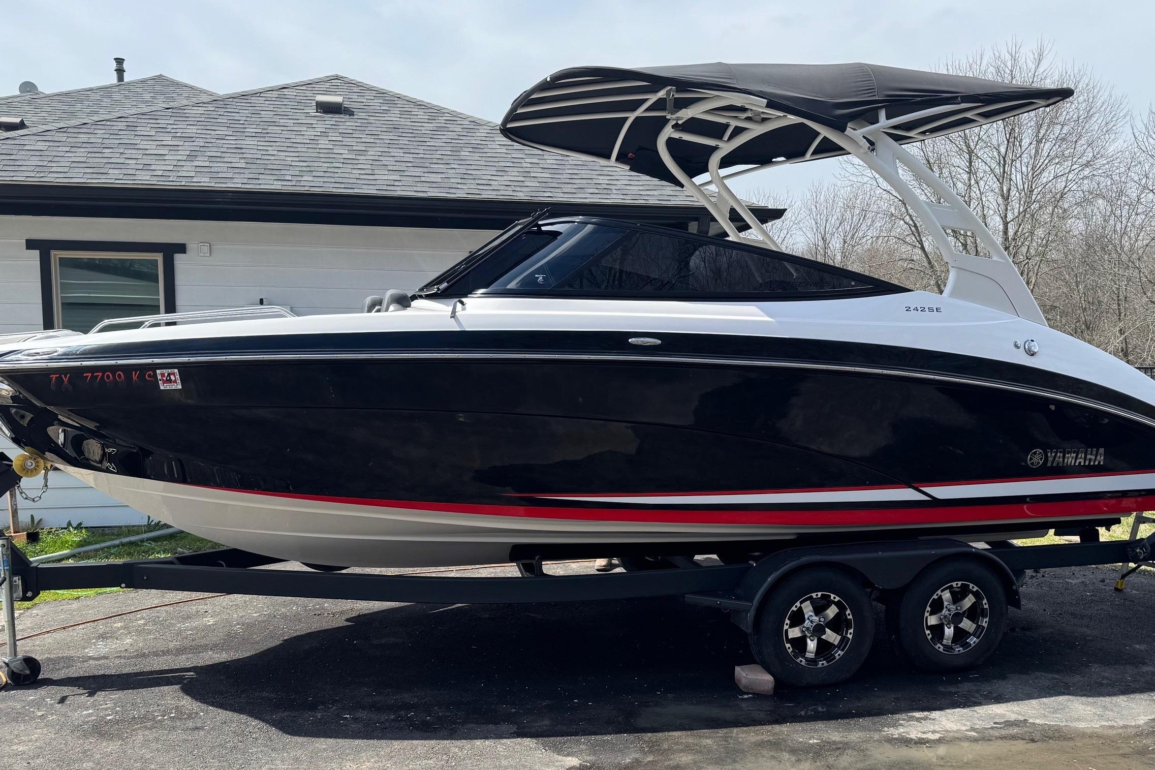 Yamaha Boats 242SE 2020 Yamaha Boats 242SE on trailer, black and white design, parked outdoors.