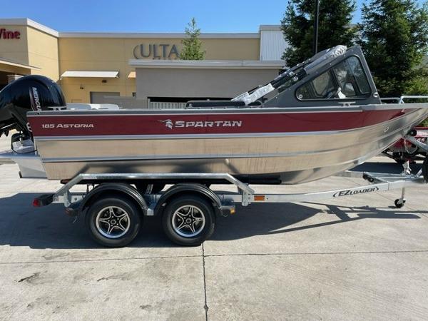 Spartan 185 Astoria 2025 Spartan 185 Astoria boat on trailer, parked outdoors, side view.