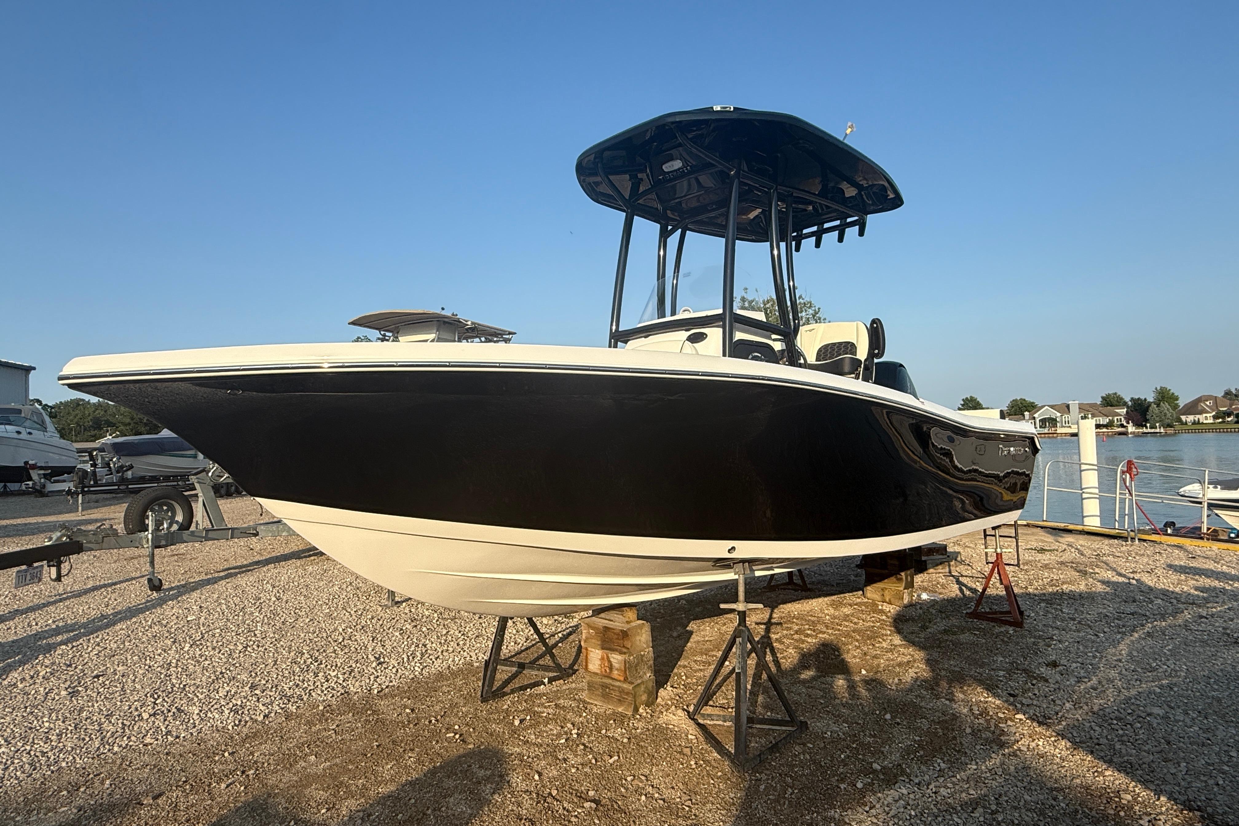 Tidewater 198 CC Adventure 2025 Tidewater 198 CC Adventure boat on stands, black hull, sunny day.