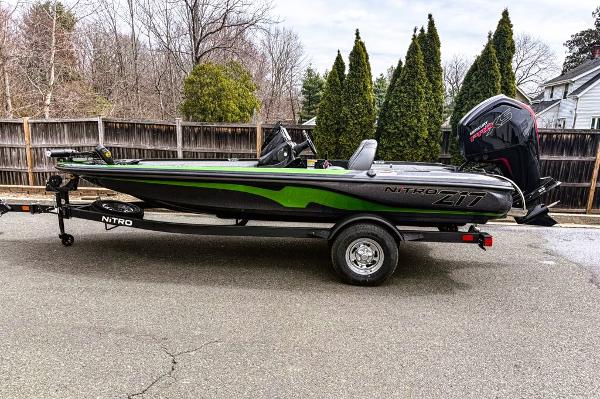 Nitro Z17 2025 Nitro Z17 boat with green accents on a trailer, parked outdoors.