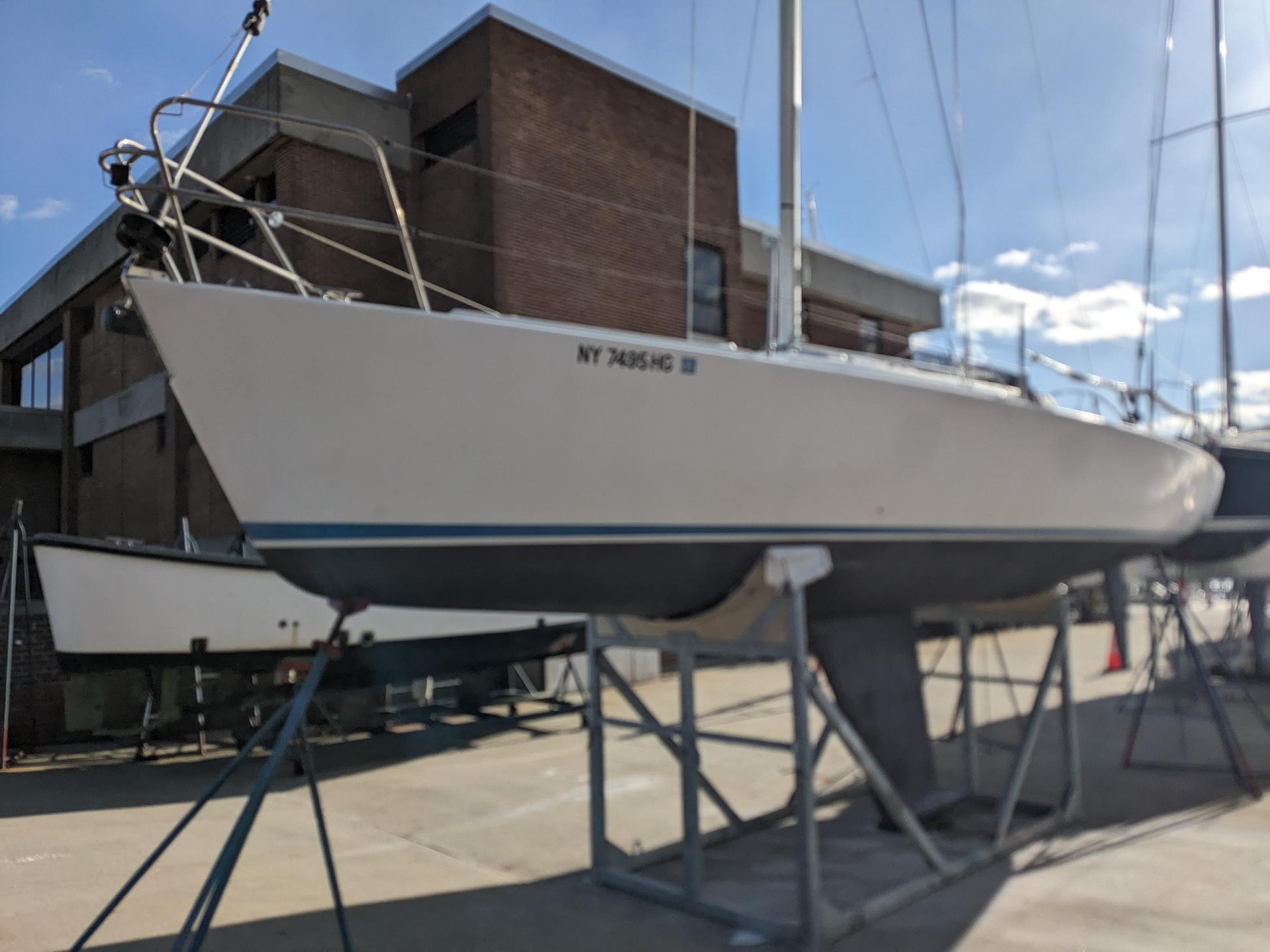 J Boats J/105 2003 J Boats J 105 sailboat on stands, outdoor setting, clear sky.