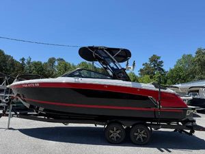 Cobalt R6 Surf 2022 Cobalt R6 Surf boat on trailer, black and red design, parked outdoors.