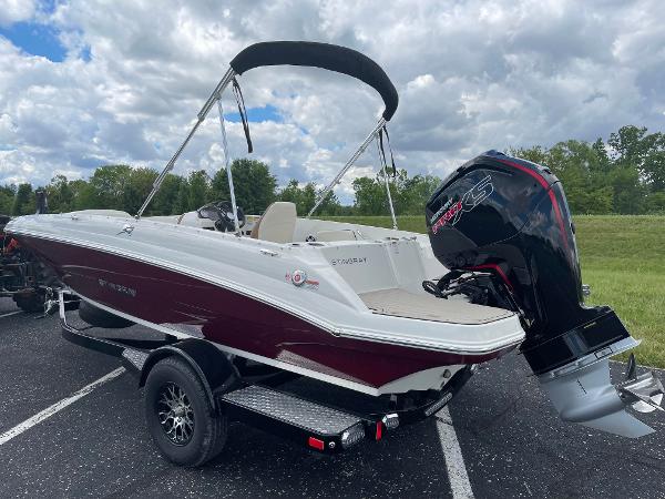 Stingray 182 SC 2024 Stingray 182 SC boat with outboard motor on trailer, parked outdoors.